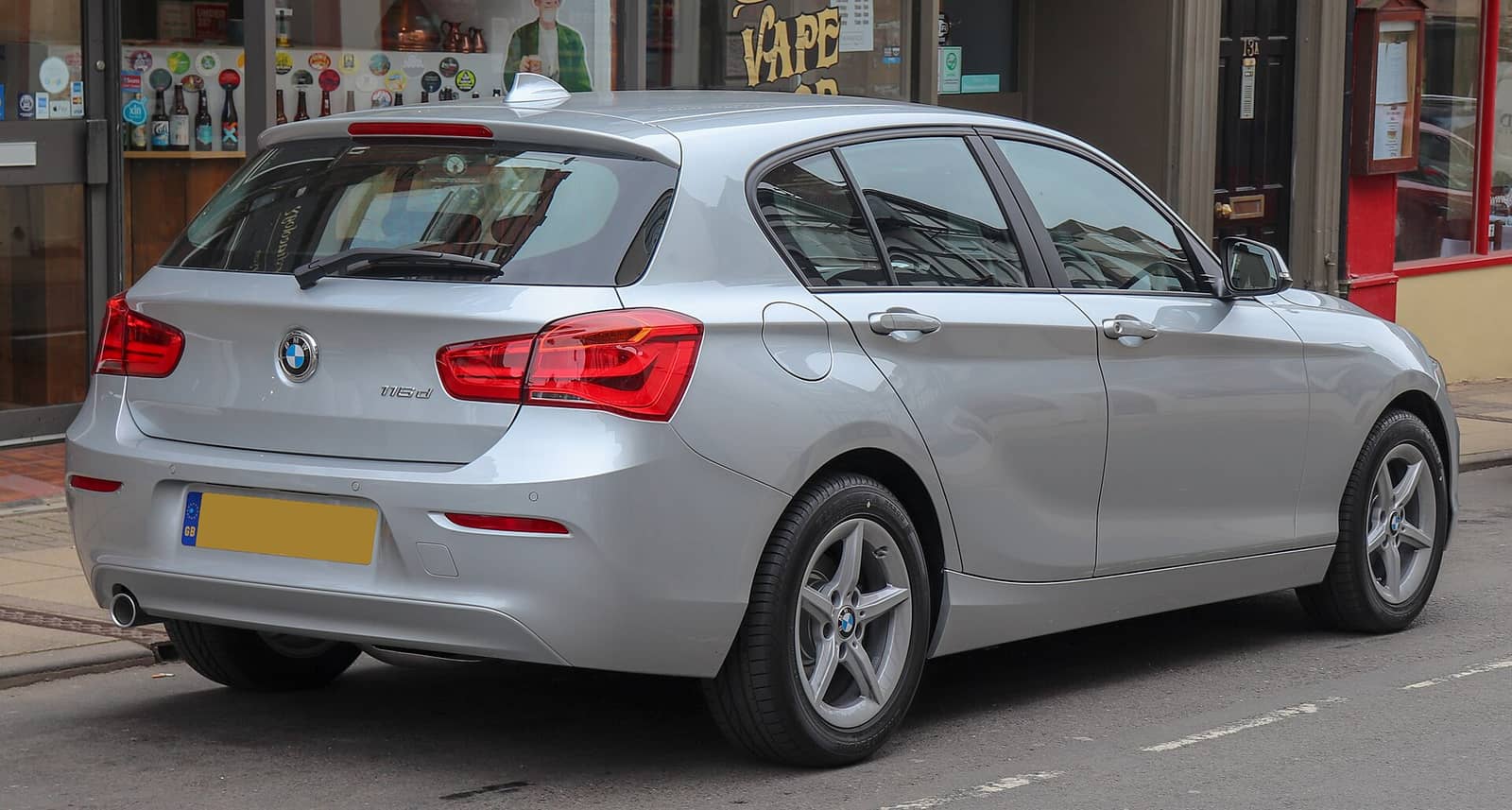Silver BMW 116d SE Business, rear three-quarter view