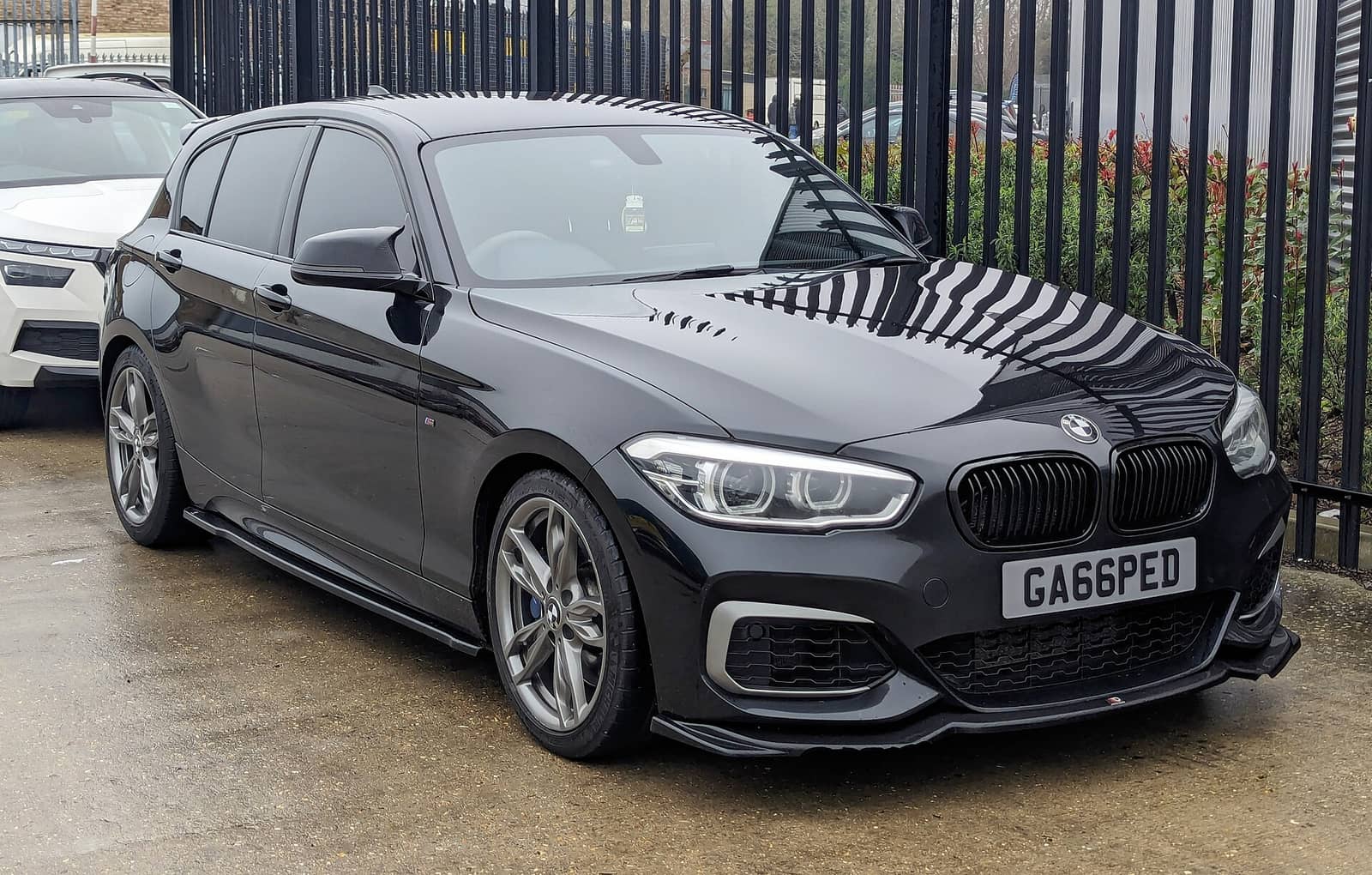 Black BMW M140i, front three-quarter view