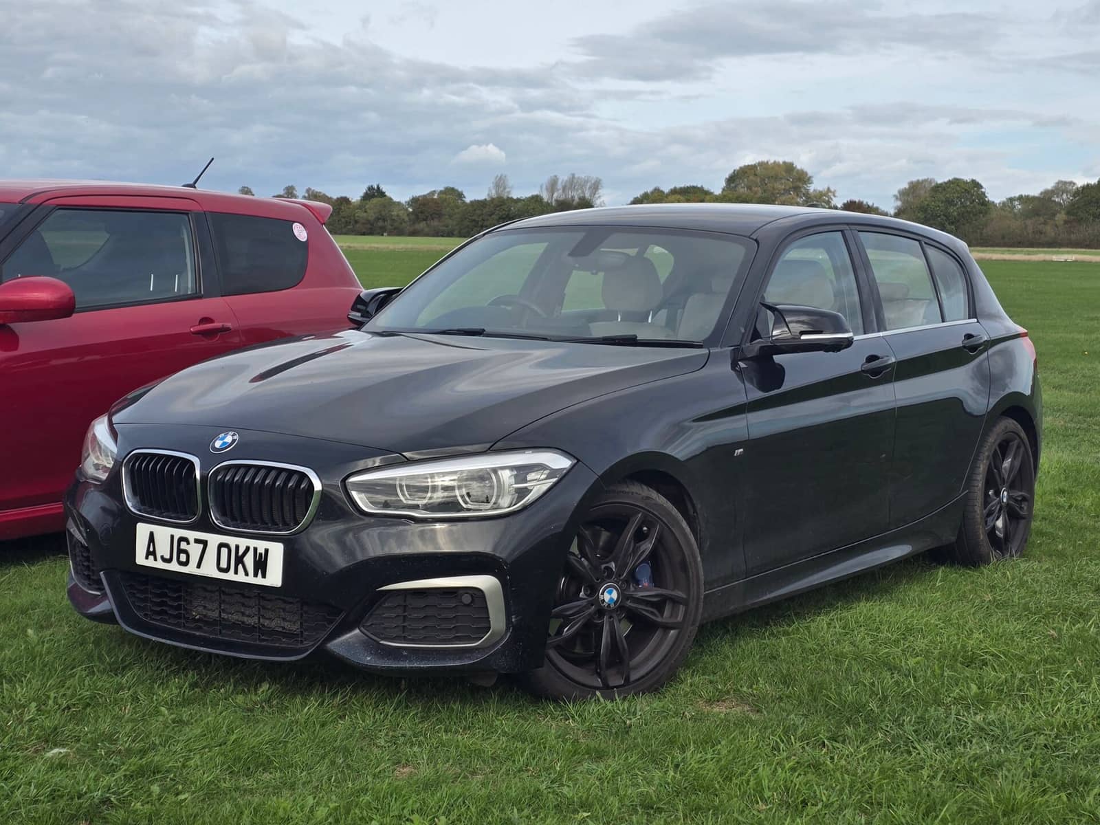 Dark grey BMW M140i, front three-quarter view