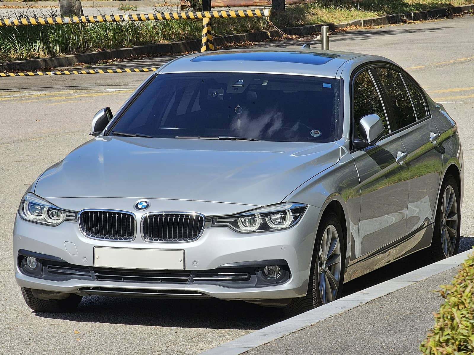 Silver BMW 320d sedan, front view