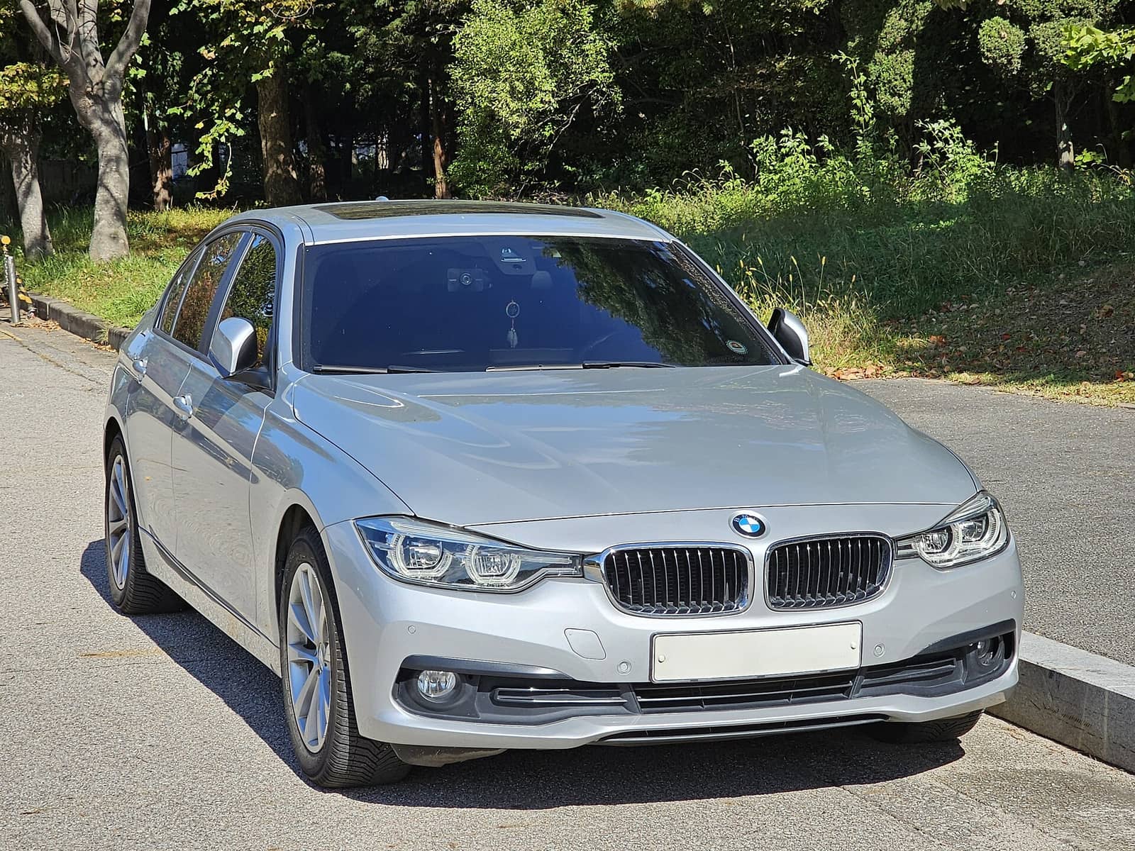 Silver BMW 320d sedan, front three-quarter view
