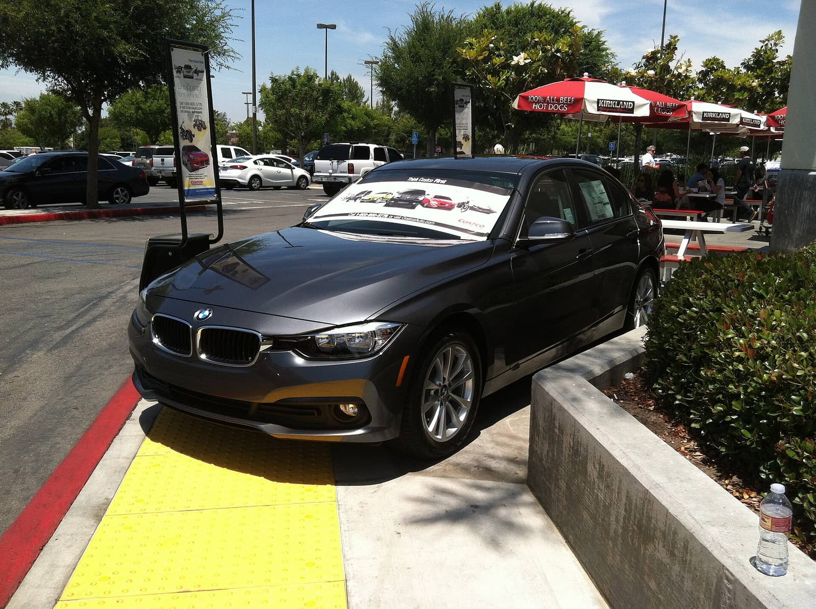 Grey BMW 320i sedan in base trim, front three-quarter view