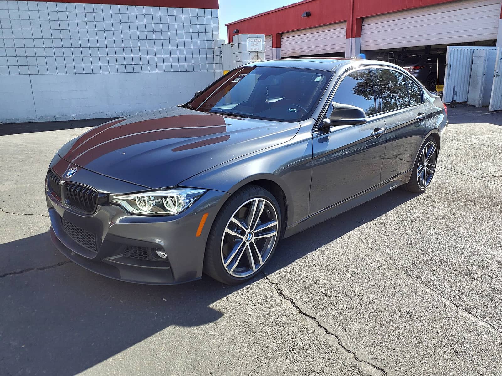 Grey BMW 340i sedan, front three-quarter view