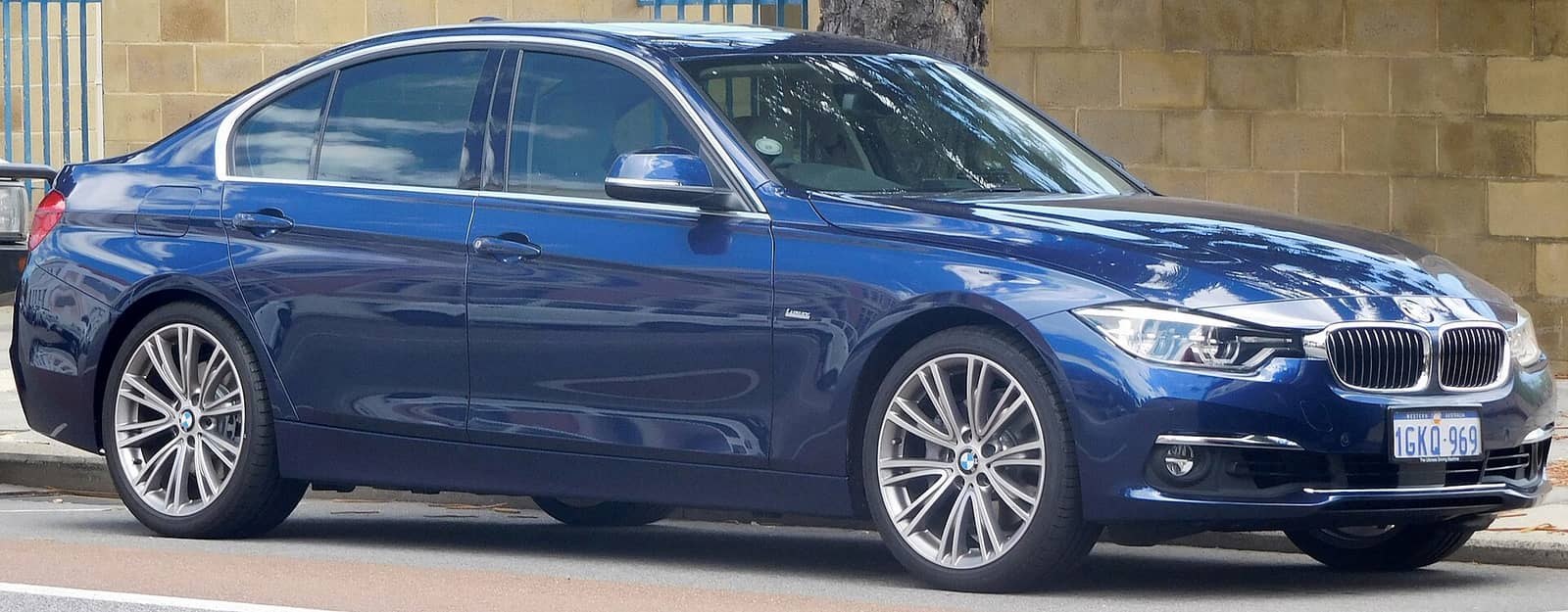 Blue BMW 340i Luxury Line sedan, front three-quarter view
