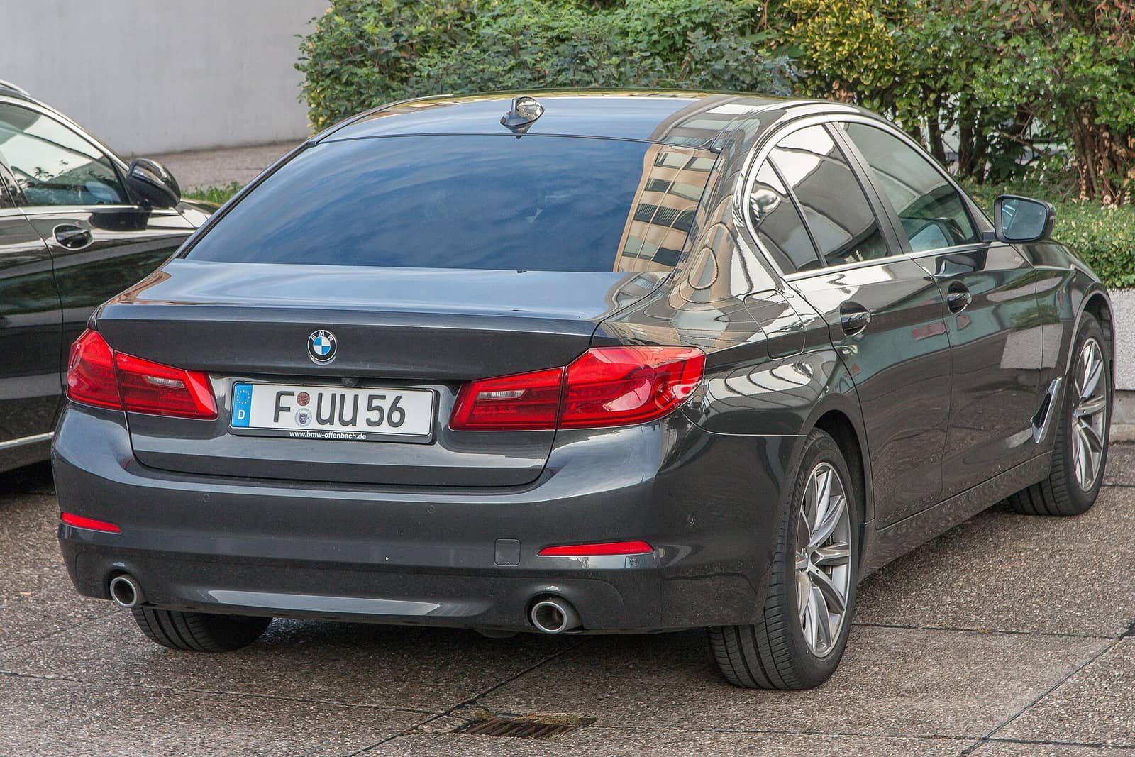 Dark grey BMW 5 Series sedan, rear view