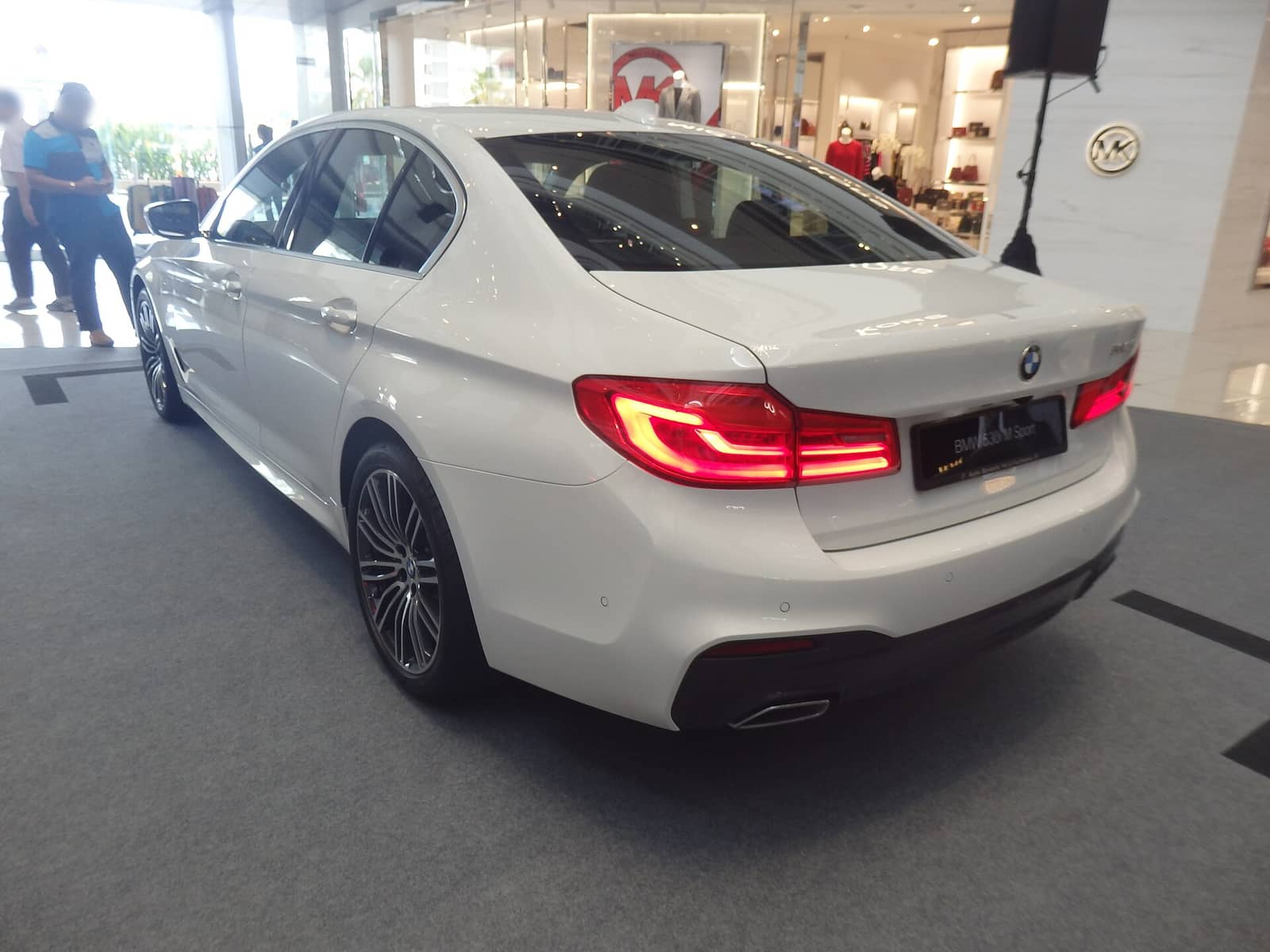 White BMW 5 Series M Sport, rear three-quarter view
